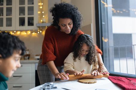 mother and daughter making gingerbread cookies in winter, enjoying top-tier indoor air quality (IAQ)